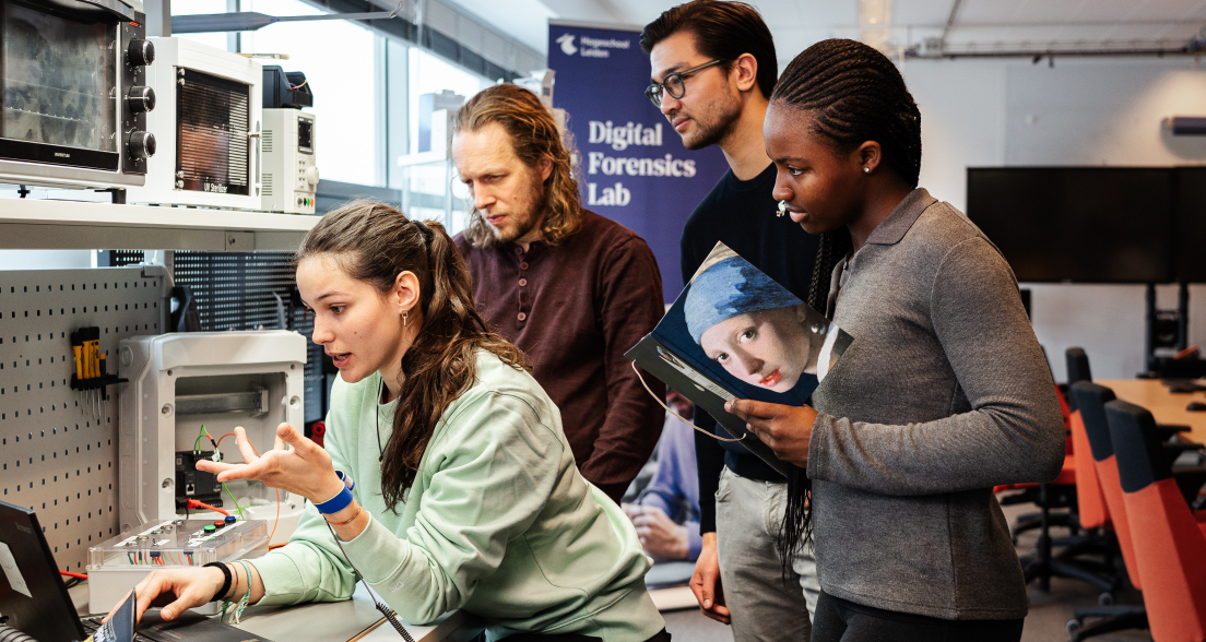 Image of 4 people in cybersecurity looking at computer screen