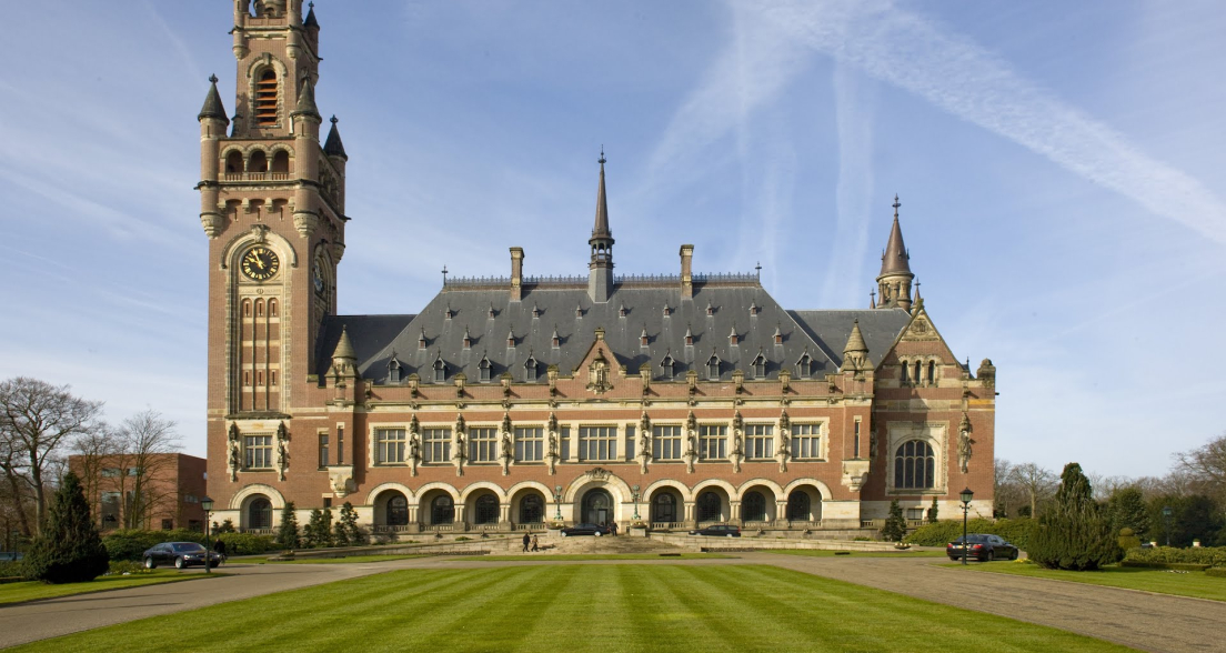 The Peace Palace with green lawns and a blue sky