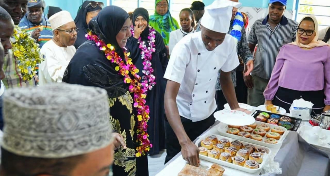 A chef serves pastries while guests watch.