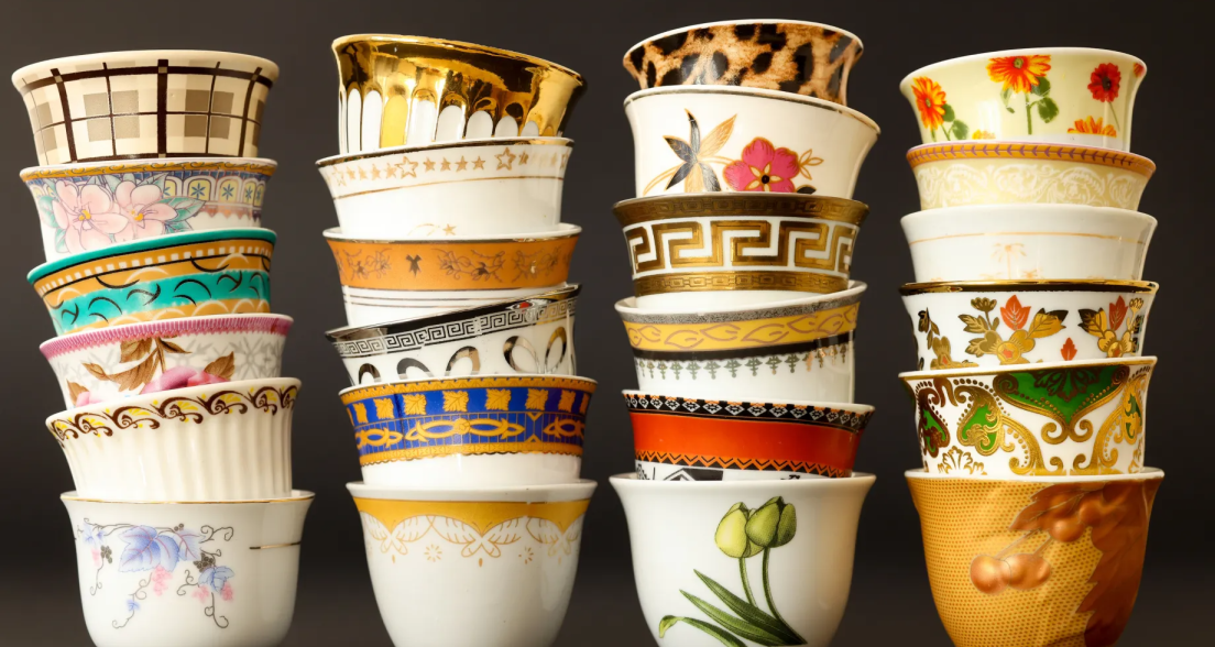A stack of various colorful teacups