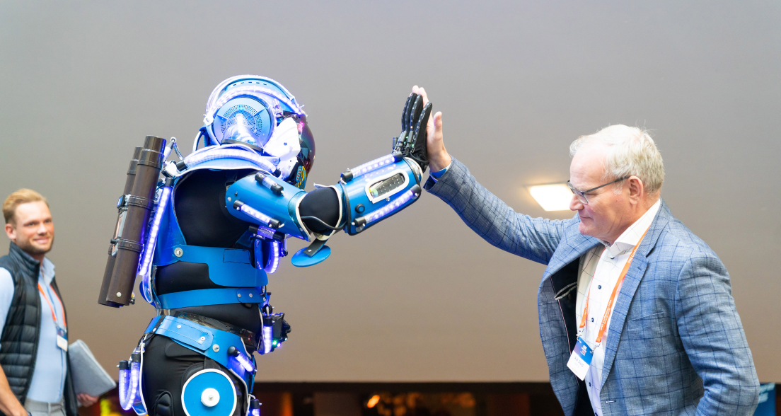 robot and man in suit doing a high five