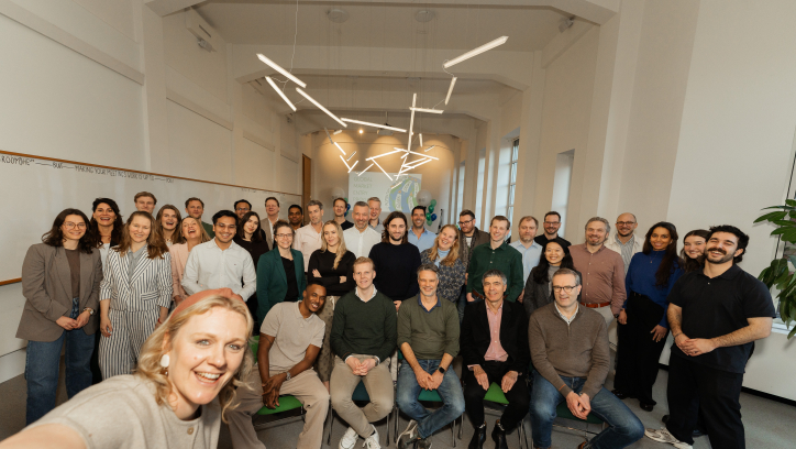 A group photo of a team in an office setting.