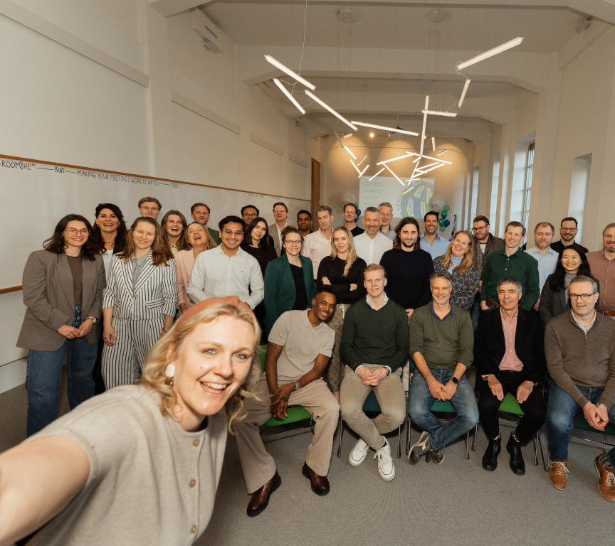 A group photo of a team in an office setting.