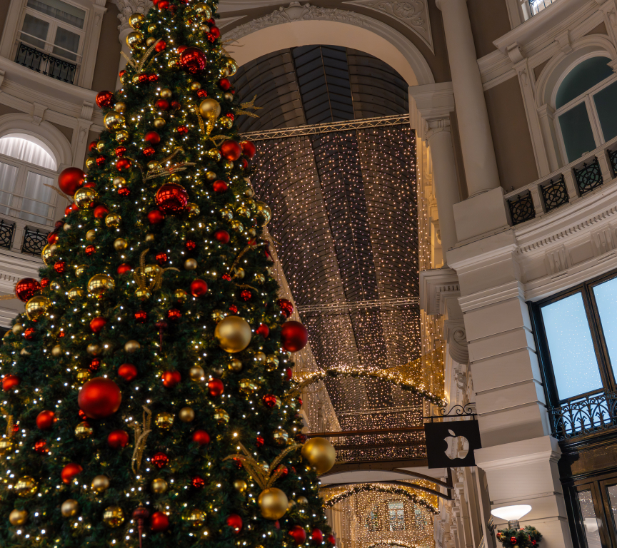 Large Christmas tree decorated with red and gold ornaments.