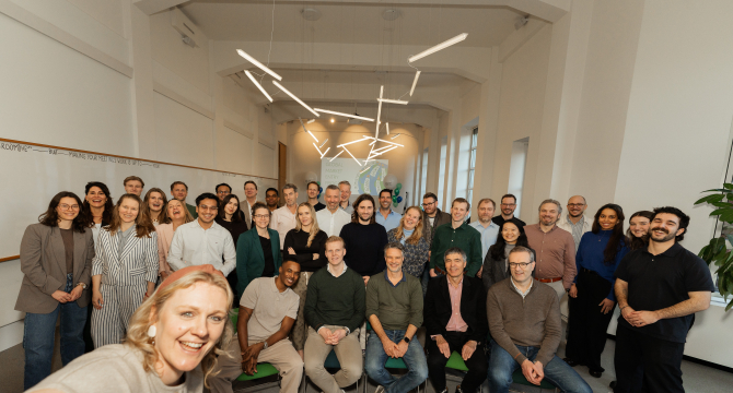 A group photo of a team in an office setting.