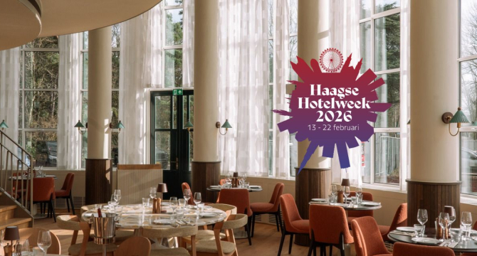 Interior of a modern dining room with round table and chairs, lighting, and large windows.