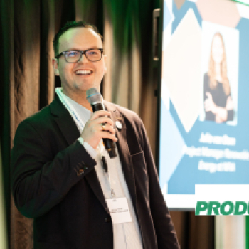 A man with a microphone is speaking on stage.