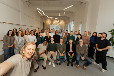 A group photo of a team in an office setting.
