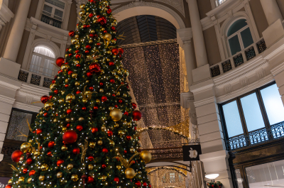 Large Christmas tree decorated with red and gold ornaments.